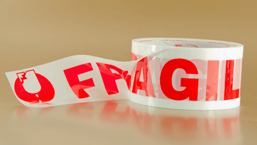 Fragile tape roll with red writing