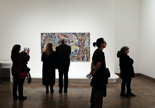People admiring modern art in an art gallery
