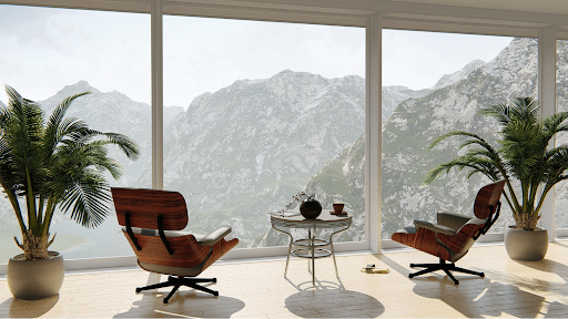 Two wooden chairs looking out to a view of mountain peaks